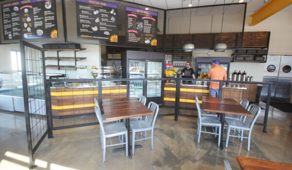 Nashville local businesses renovation project for Sunflower Cafe. Lotus Building Group helped design and build the interior elements, including the benches, shelving, menu boards, and custom railing. Contact Lotus for custom renovations for commercial businesses.