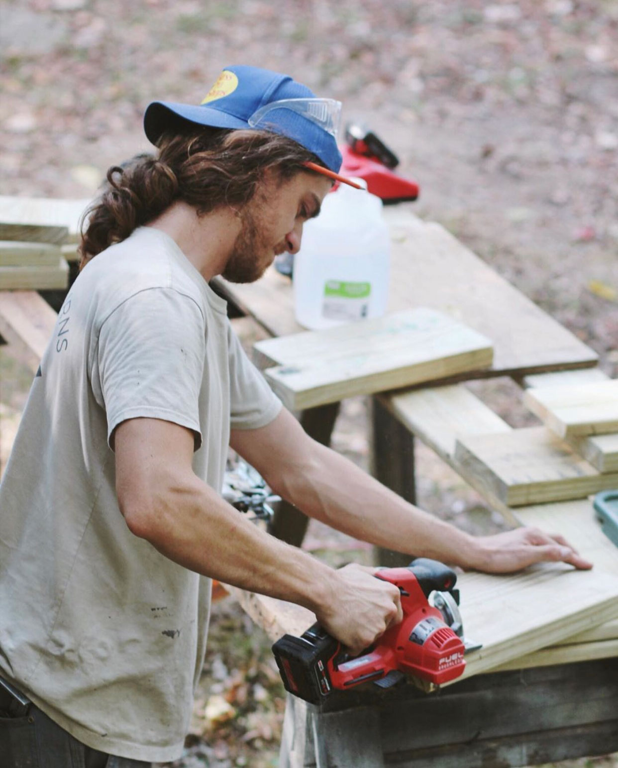 Team member of Lotus Building Group cutting and measuring wood for a project. Contact Lotus Building Group as your custom home renovation contractor in Nashville, TN.
