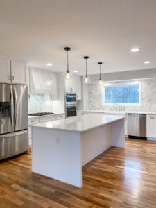 Residential kitchen renovation project. This kitchen features white cupboards and stainless steel accent fixtures. Contact Lotus Building Group as your kitchen remodel contractor in Nashville, TN.