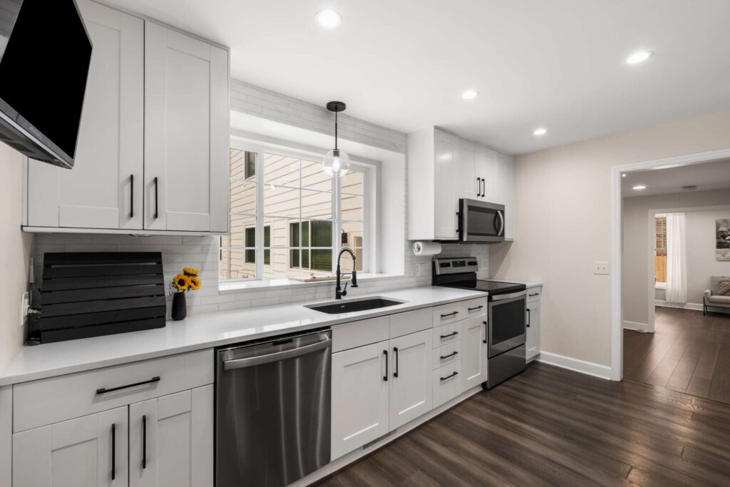Residential kitchen renovation project. This kitchen features white cupboards and stainless steel accent fixtures. Contact Lotus Building Group as your kitchen remodel contractor in Nashville, TN.