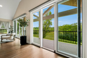Sliding screen doors open up to a patio with a roof. Contact Lotus Building Group for your new home construction projects in Nashville, TN.